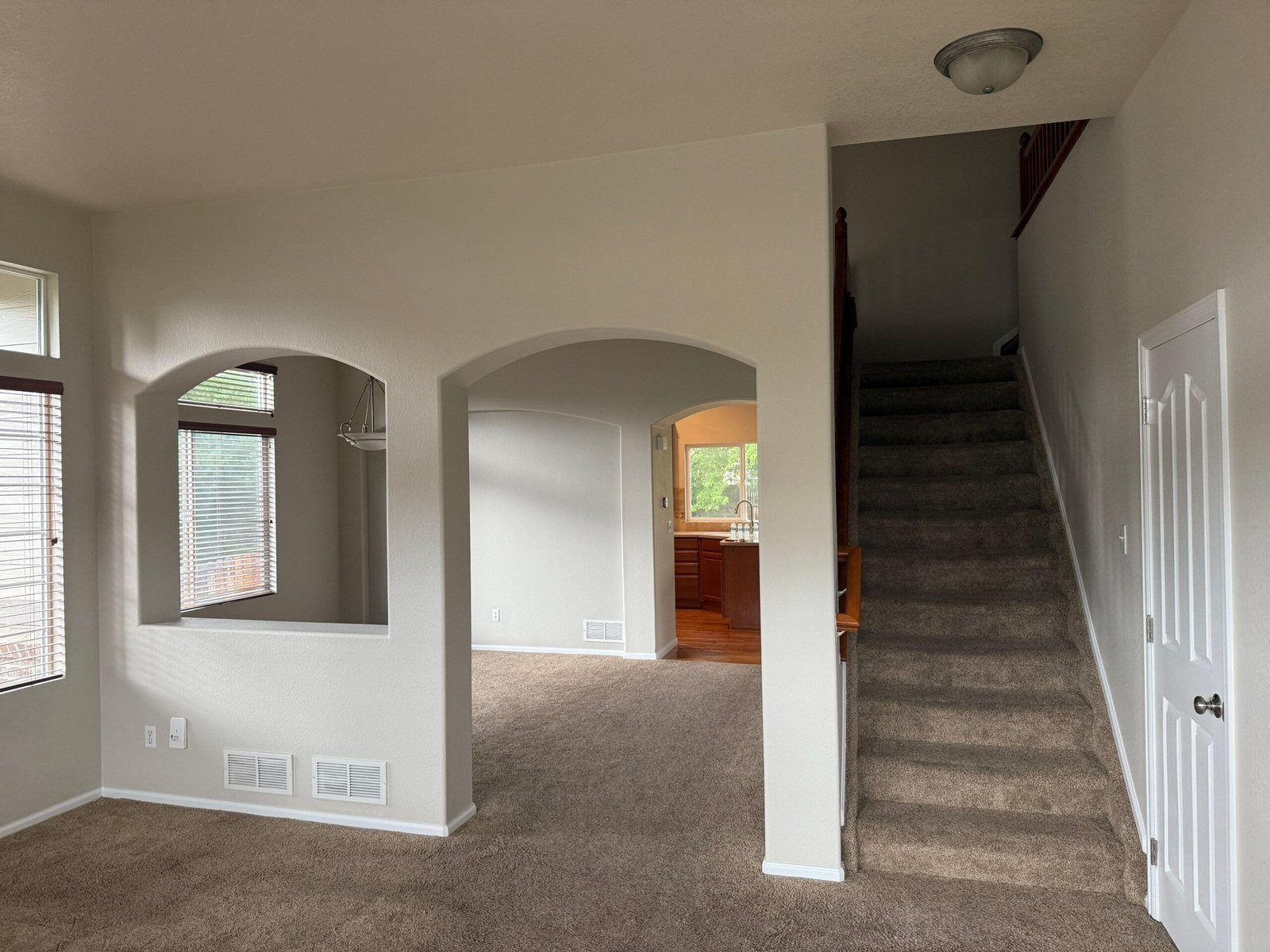 Living room with fireplace and chandelier after a fresh neutral interior repaint