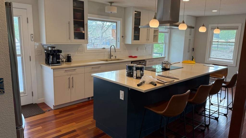Charcoal gray painted kitchen cabinets with a custom range hood in Gunbarrel, Colorado