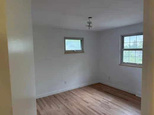 After: neutral gray painted bedroom, hardwood floor, Elements Painting project on the Colorado Front Range