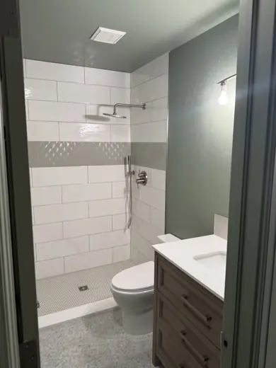 Bathroom with white tile shower and green walls, Elements Painting project on the Colorado Front Range