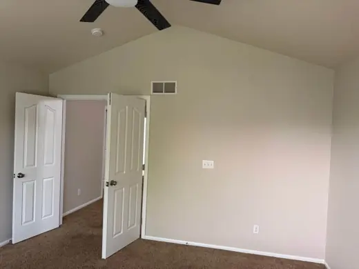 Bedroom with white doors and warm neutral wall paint, Elements Painting project on the Colorado Front Range