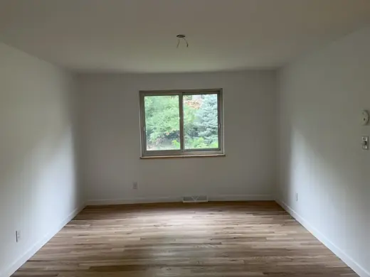 Beige bedroom with window and light wood floor, Elements Painting project on the Colorado Front Range