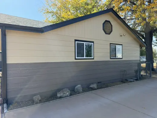 Beige garage exterior with white window trim, Elements Painting project on the Colorado Front Range