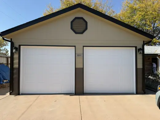 Beige garage with two white doors, brick posts, Elements Painting project on the Colorado Front Range