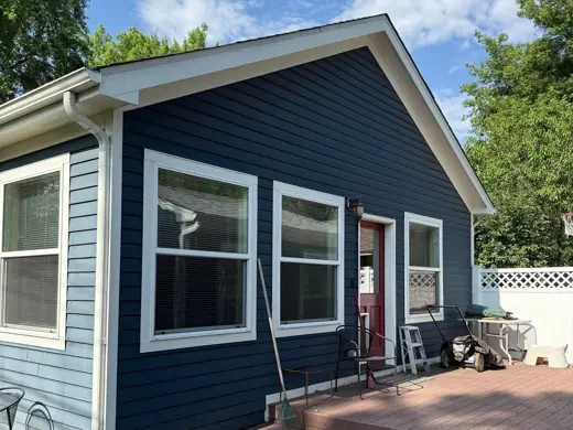 Blue house with white trim and dark navy door, Elements Painting project on the Colorado Front Range