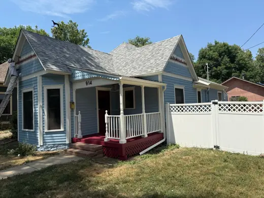 Blue Victorian cottage after painting, white porch railings, Elements Painting project on the Colorado Front Range