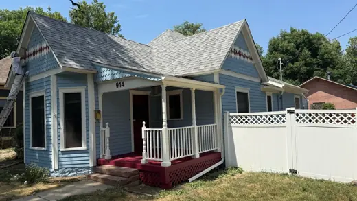 Blue Victorian cottage with white trim and fence, Elements Painting project on the Colorado Front Range