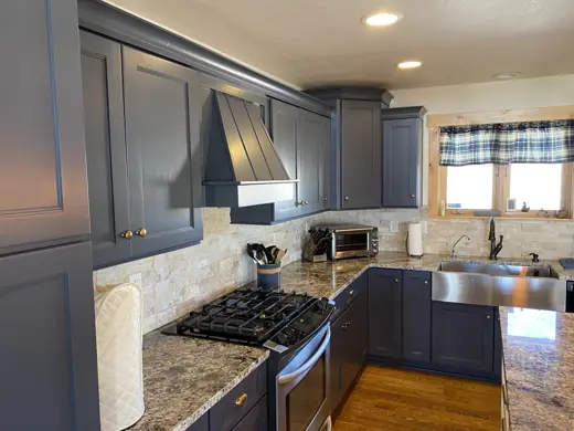 Charcoal gray kitchen cabinets with granite backsplash and hood, Elements Painting project on the Colorado Front Range