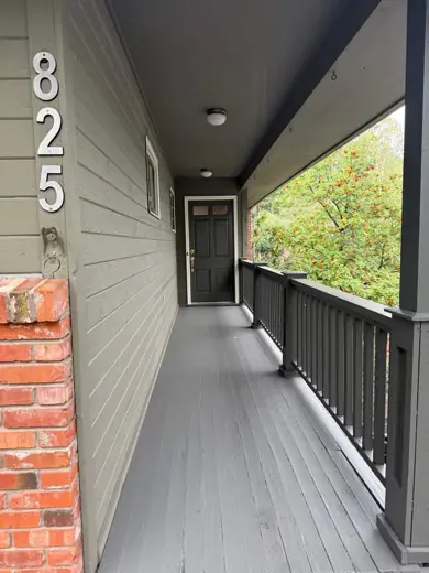 Covered porch with gray deck boards and white railing, Elements Painting project on the Colorado Front Range