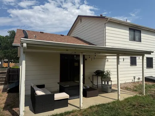Cream house with brown roof and covered patio, Elements Painting project on the Colorado Front Range