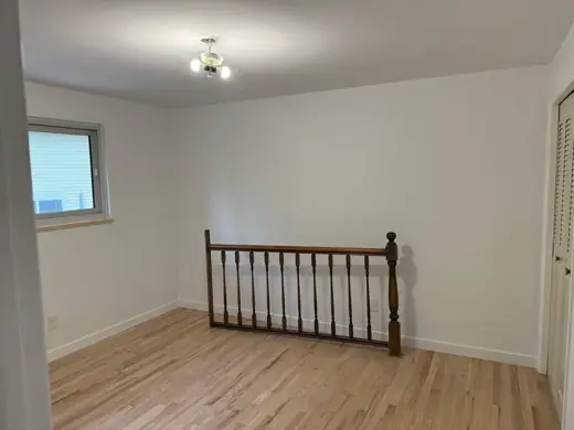 Cream living room walls, oak floor, wood stair railing, Elements Painting project on the Colorado Front Range