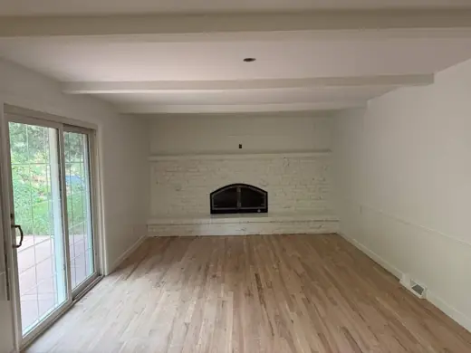 Cream living room with painted brick fireplace, sliding door, Elements Painting project on the Colorado Front Range