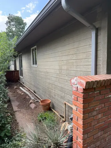 Cream siding home side with red brick and copper trim, Elements Painting project on the Colorado Front Range