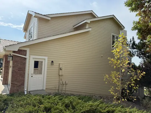 Cream siding with white trim and brick base, Elements Painting project on the Colorado Front Range