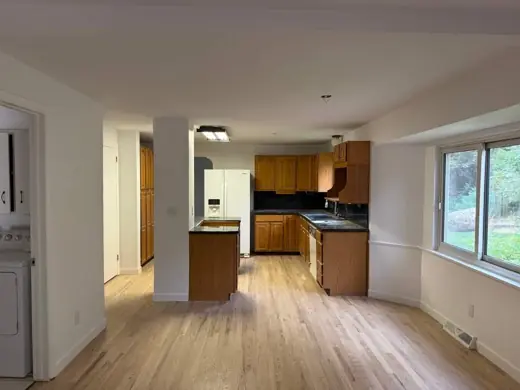 Cream walls, open kitchen with oak cabinets, wood floor, Elements Painting project on the Colorado Front Range