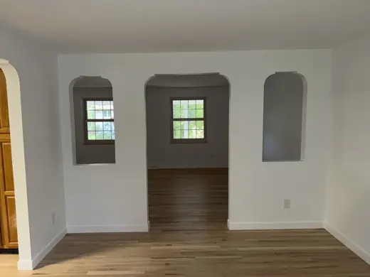 Cream walls with arched openings, light wood floor, Elements Painting project on the Colorado Front Range