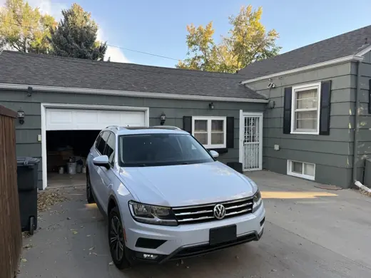 Dark blue-gray home and garage with white trim, driveway, Elements Painting project on the Colorado Front Range