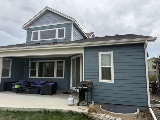 Dark blue-gray house with white trim and dormer, patio, Elements Painting project on the Colorado Front Range