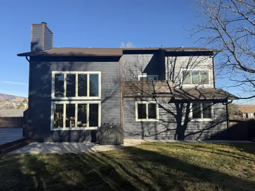 Dark gray home with large windows and brick chimney, Elements Painting project on the Colorado Front Range
