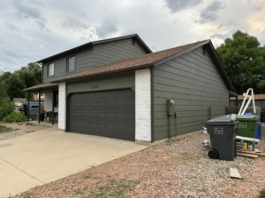 Dark gray home with white garage door and brown roof, Elements Painting project on the Colorado Front Range