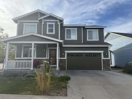 Dark gray two-story home with white trim, driveway, Elements Painting project on the Colorado Front Range