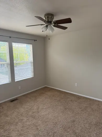 Empty bedroom with ceiling fan and freshly painted light walls, Elements Painting project on the Colorado Front Range