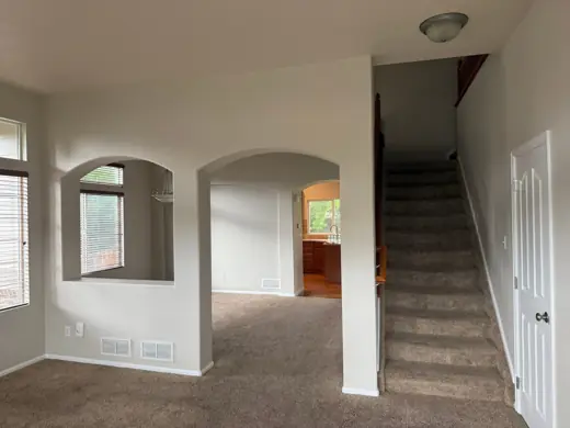 Empty room with arched windows, neutral walls and carpeted stairs, Elements Painting project on the Colorado Front Range