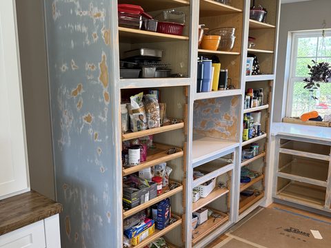 In progress: Pantry built-in cabinets sanded, doors off, shelves full, Elements Painting project on the Colorado Front Range