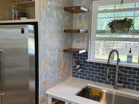 In progress: Kitchen wall and shelves sanded, stainless fridge, blue tile backsplash, Elements Painting project on the Colorado Front Range