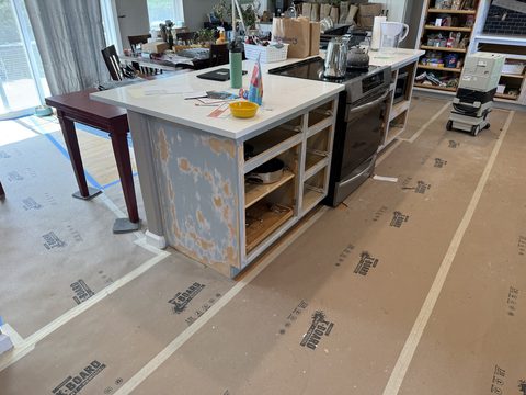 In progress: Kitchen island stripped, doors removed, floor protection down, Elements Painting project on the Colorado Front Range