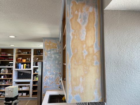 In progress: Upper cabinet end panel sanded raw, pantry beyond, Elements Painting project on the Colorado Front Range