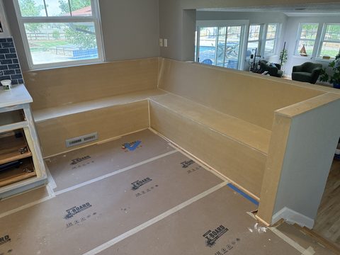 In progress: Raw unpainted MDF built-in corner bench, floor protection, Elements Painting project on the Colorado Front Range