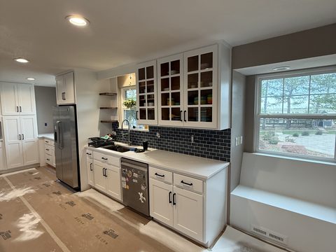 Cabinet painting, white shaker kitchen, glass uppers, blue backsplash, Elements Painting project on the Colorado Front Range