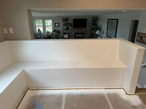 Built-in painting, white built-in bench, living room with fireplace beyond, Elements Painting project on the Colorado Front Range