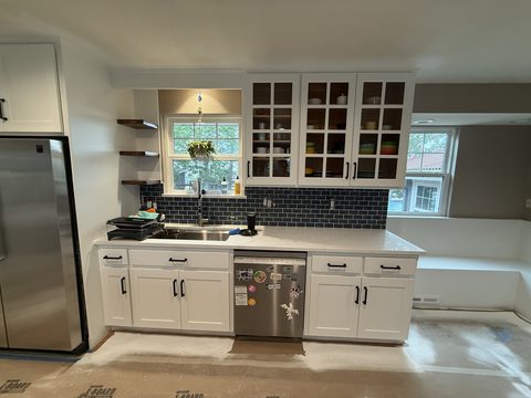 Cabinet painting, white sink wall, glass uppers, blue tile, bench at right, Elements Painting project on the Colorado Front Range