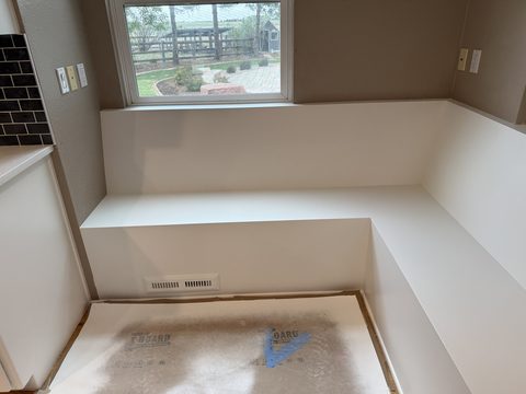 Built-in painting, white bench under window, taupe walls, garden view, Elements Painting project on the Colorado Front Range