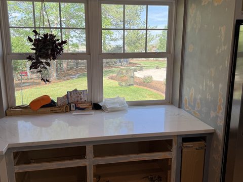 In progress: Kitchen window counter with stripped bare cabinet boxes, patched walls, Elements Painting project on the Colorado Front Range