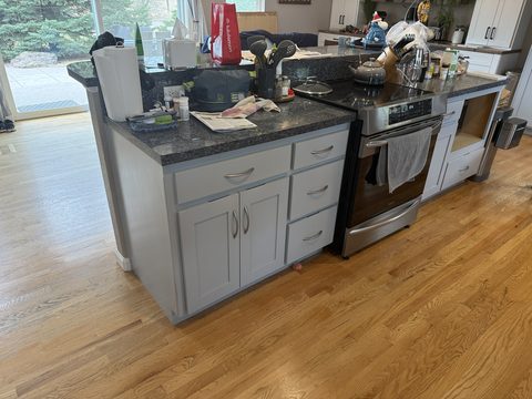 Cabinet painting, light grey island base cabinets by stainless range, Elements Painting project on the Colorado Front Range