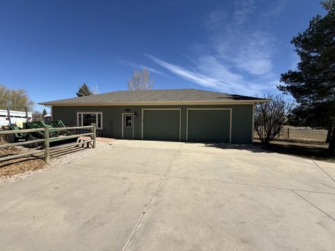 Exterior painting, sage green detached garage, two doors, white trim, concrete drive, Elements Painting project on the Colorado Front Range
