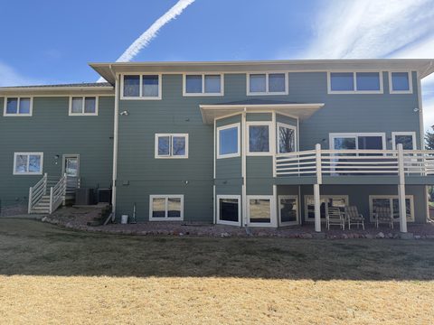 Exterior painting, blue-gray lap siding rear elevation, white trim, deck railing, sunny, Elements Painting project on the Colorado Front Range