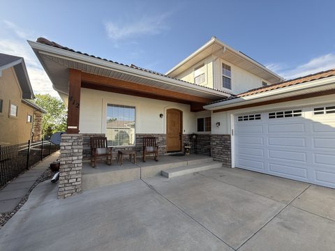 Exterior painting, cream stucco entry, wood beam, stone columns, Elements Painting project on the Colorado Front Range