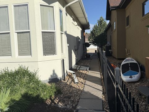 Exterior painting, side yard cream stucco, iron fence, Elements Painting project on the Colorado Front Range