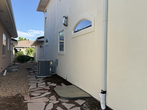 Exterior painting, side yard cream stucco, flagstone path, downspouts, Elements Painting project on the Colorado Front Range