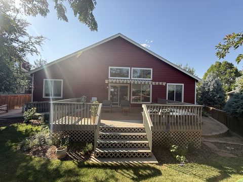 Exterior painting, rear of barn-red lap-siding home, grey deck, Elements Painting project on the Colorado Front Range