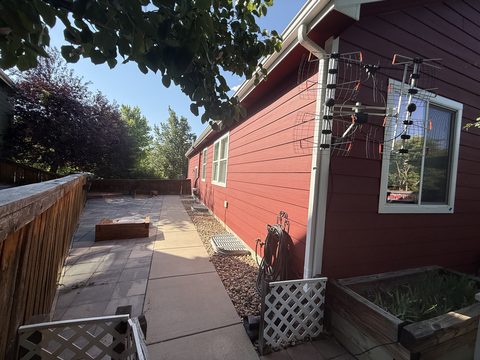 Exterior painting, red siding side yard with patio, Elements Painting project on the Colorado Front Range