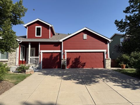 Exterior painting, barn-red home front, red garage doors, white trim, blue sky, Elements Painting project on the Colorado Front Range