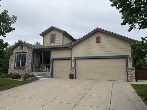 Before painting: Tan siding home, blue-grey trim, tan garage doors, Elements Painting project on the Colorado Front Range