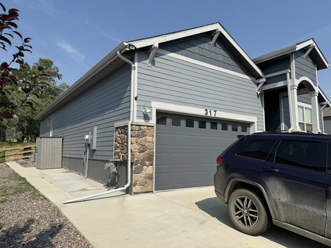 Exterior painting, blue-grey siding home, grey garage door, Elements Painting project on the Colorado Front Range