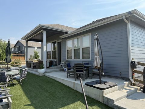 Exterior painting, blue-gray lap siding, white trim, covered back patio with furniture, Elements Painting project on the Colorado Front Range
