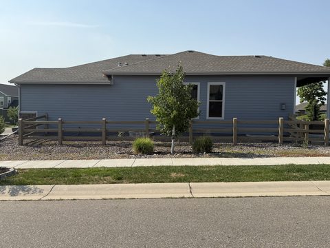 Exterior painting, blue-gray siding side elevation, split-rail fence, street view, Elements Painting project on the Colorado Front Range